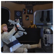 The garage is cluttered and worn, but a friendly peaceful atmosphere permeates the low beige chamber. Artoo is standing in one corner while Threepio takes an oil bath. Luke seems to be lost in thought as he plays with a model of a Skyhopper. Finally Luke's frustrations get the better of him. LUKE: "It just isn't fair. Oh, Biggs is right. I'm never gonna get out of here!" #starwars #anhwt #starwarstoycrew #jbscrew #blackdeathcrew #starwarstoypix #toyshelf 
